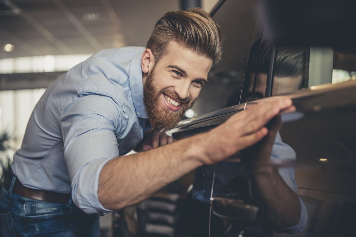 Man with a beard checking out the side of his car | Car Insurance in Charleston, IL by Cooper Bumpus Insurance Agency